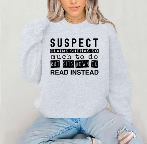 PREORDER SUSPECT CLAIMS SHE HAS SO MICH TO DO BUT SHE SITS DOWN TO READ INSTEAD